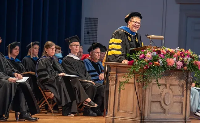 莎拉Willie-LeBreton in academic regalia, speaking at the President's Welcome Assembly.